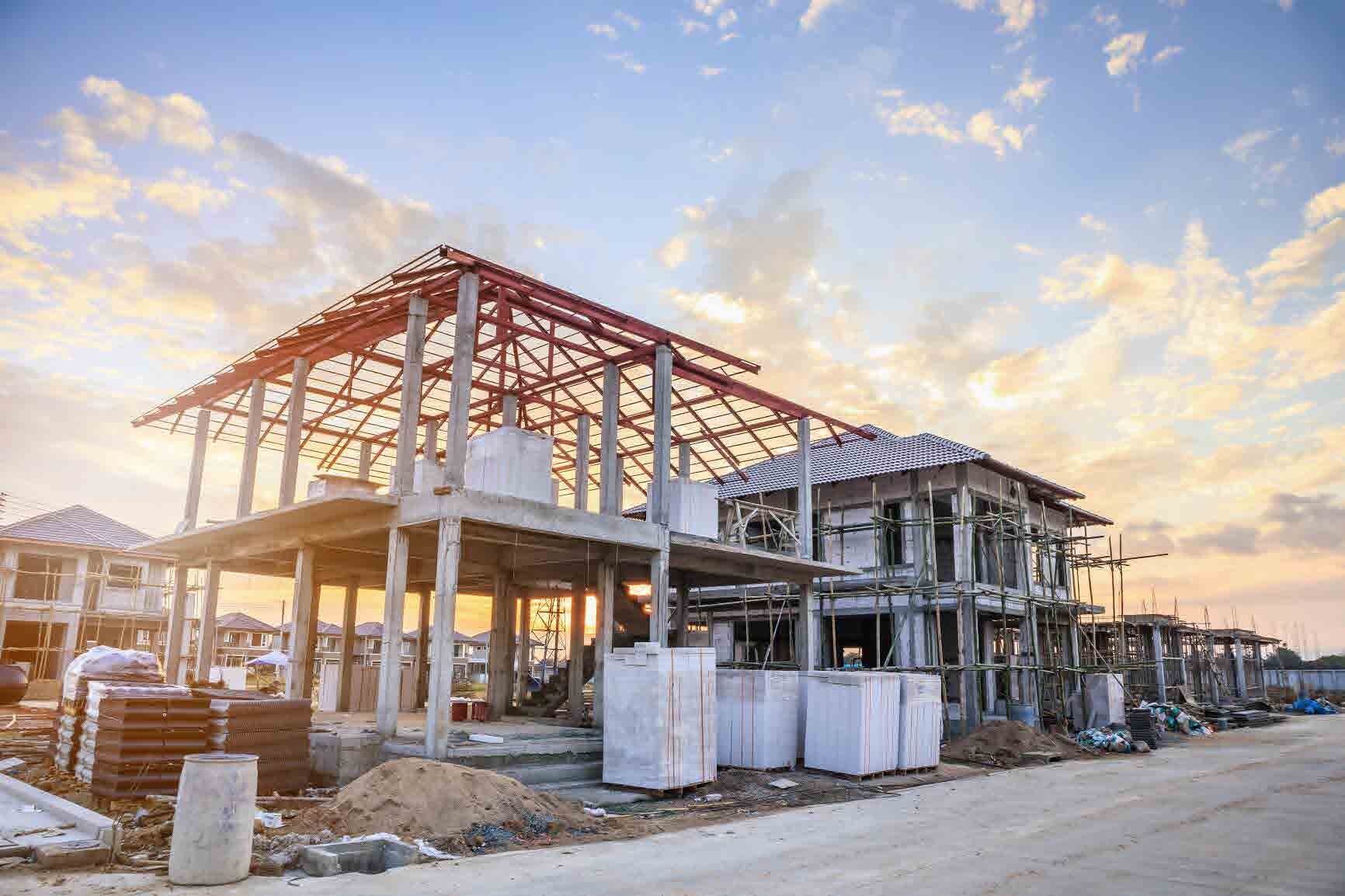 Steel-frame building under construction at dusk